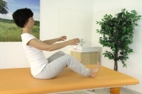 Straightening the spine in sitting position with legs in front